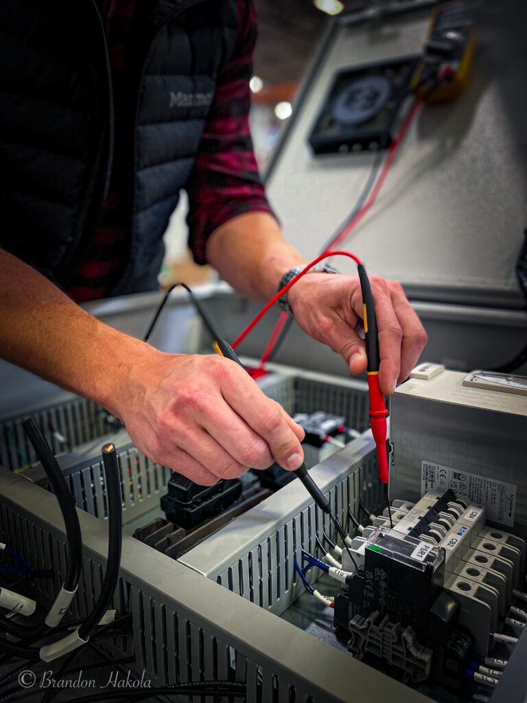 WIT Technician Inspects an Electrical Panel